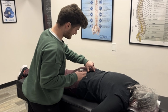 Chiropractor Oak Creek WI Noah Shulz Patient Adjustment